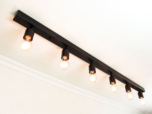 Black cluster light fixture with multiple bulbs on a ceiling