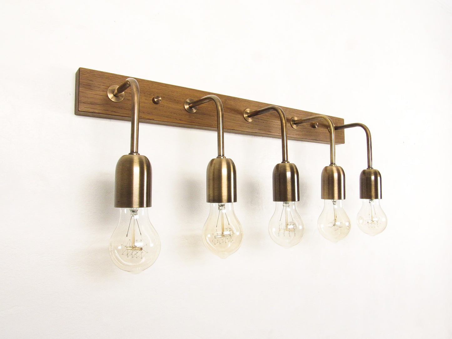 Brass & Oak wall-mounted light fixture with five exposed bulbs on a white background