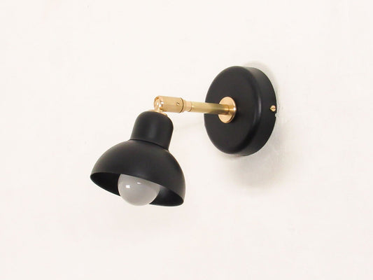 Black dome wall sconces with brass accents on a white background